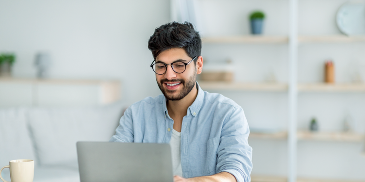 A marketing professional uses a laptop to calculate the CPM or cost per thousand impressions, of a marketing campaign.