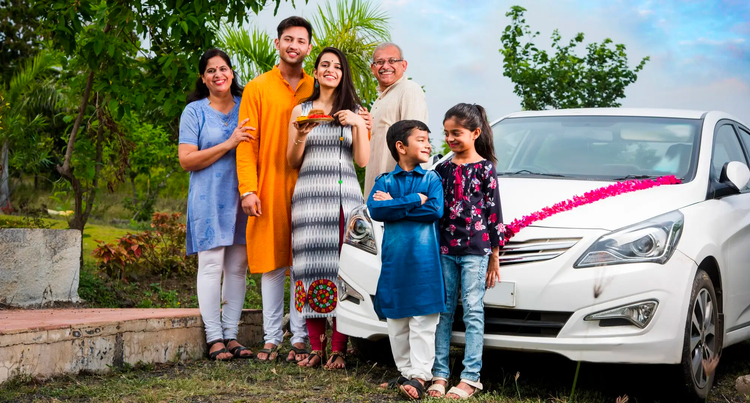 Happy Indian family in front of car