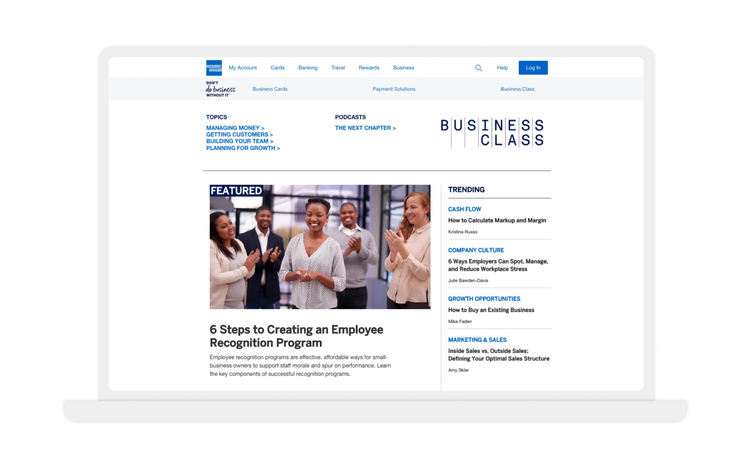 Laptop screen showing featured article on employee recognition and trending business topics.