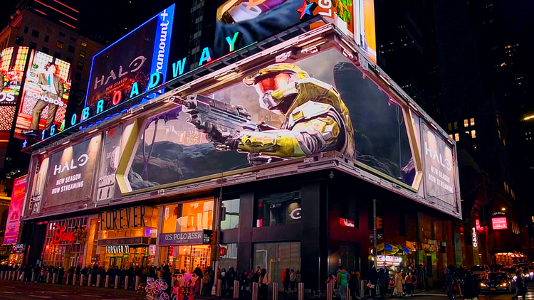 Large Times Square billboard showing Halo series ad for Paramount+ with vibrant city lights.