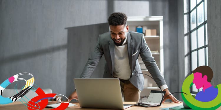 Businessman looking at a laptop smiling