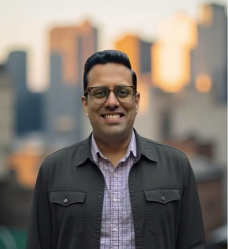 A person wearing glasses and a jacket AI-generated content may be incorrect.