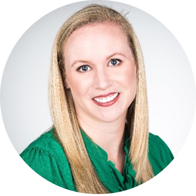 A person with blonde hair smiling Description automatically generated