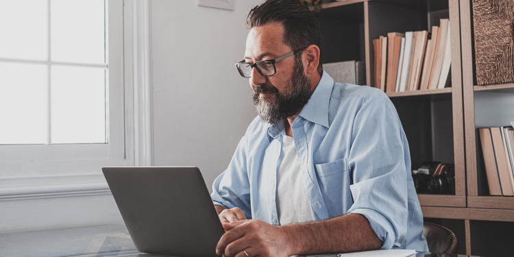 A marketer generates an email list using a laptop.