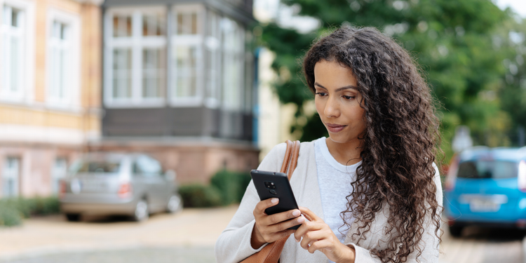 An online shopper uses a mobile ecommerce app while on the go.