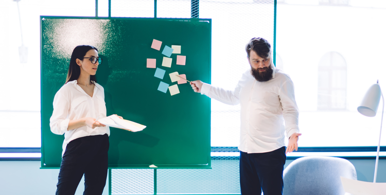 Man and women leading a stand-up meeting