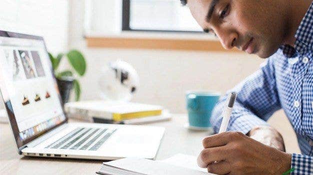 Man at computer writing about application portfolio management