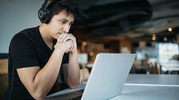 Worker in front of laptop managing priorities