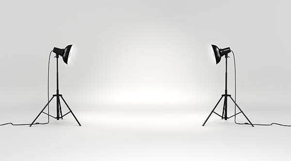 two photography lights facing each other in a studio setting