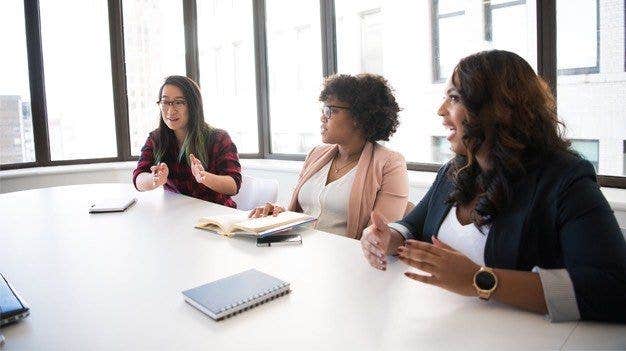 Executive team creating a mission statement in a board room