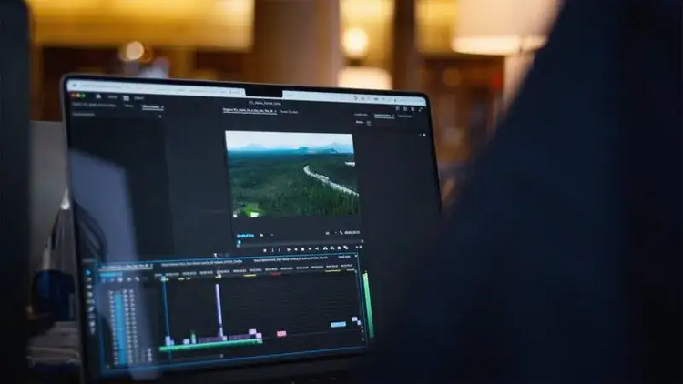A laptop screen showing a video being edited with Adobe Premiere Pro.