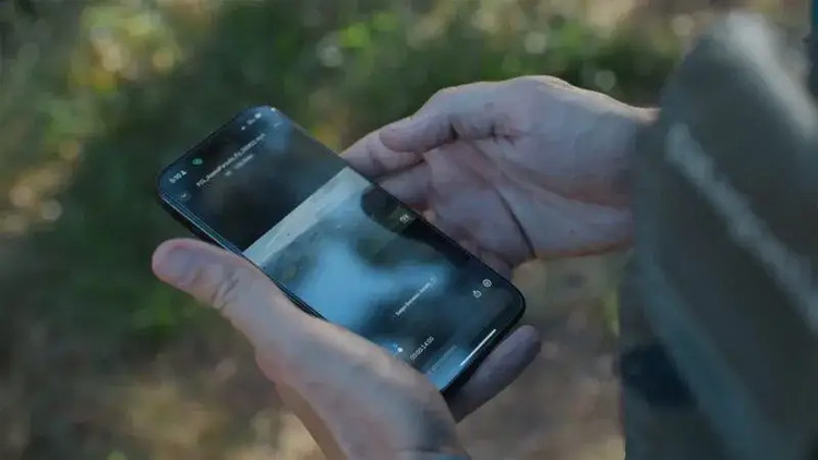 Hands holding an iPhone, with Frame.io on the screen.
