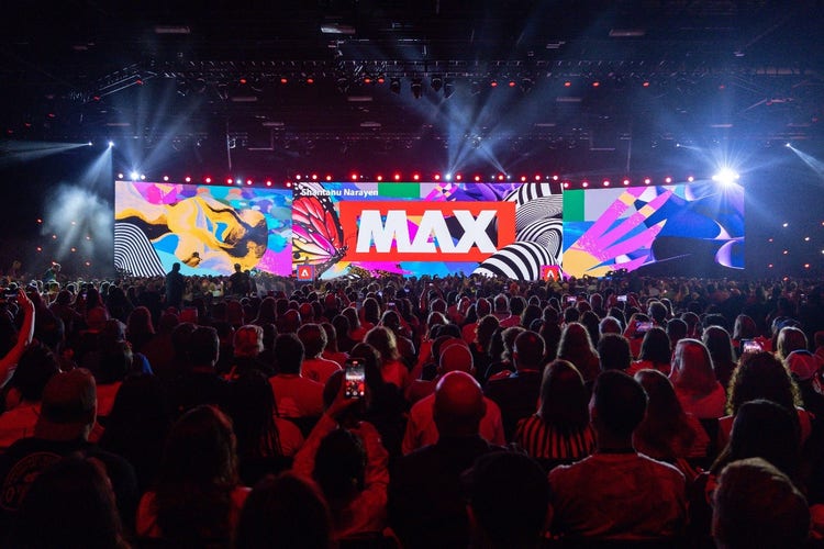 Huge audience crowding the Adobe MAX conference main stage screen.