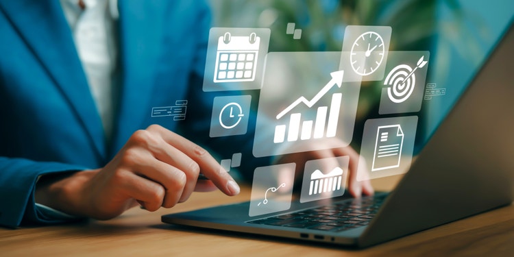 Person using laptop with floating digital icons representing productivity tools, analytics, and scheduling