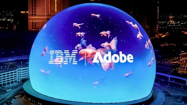 Las Vegas Sphere showing virtual moving fish in a fishbowl with IBM and Adobe logos