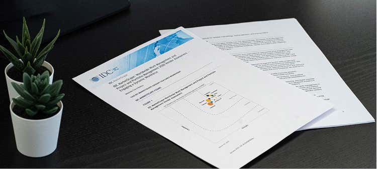 Front cover of an IDC MarketScape report on a desk