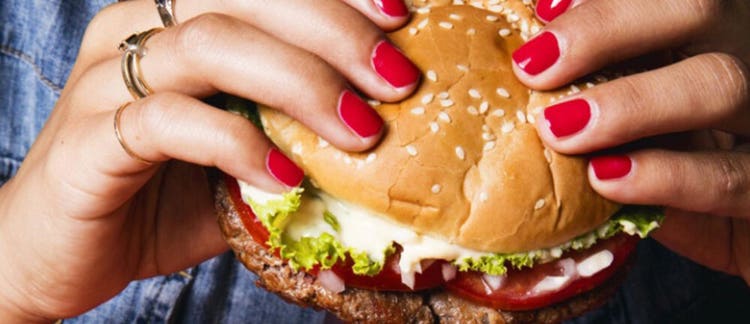 Woman holding hammburger