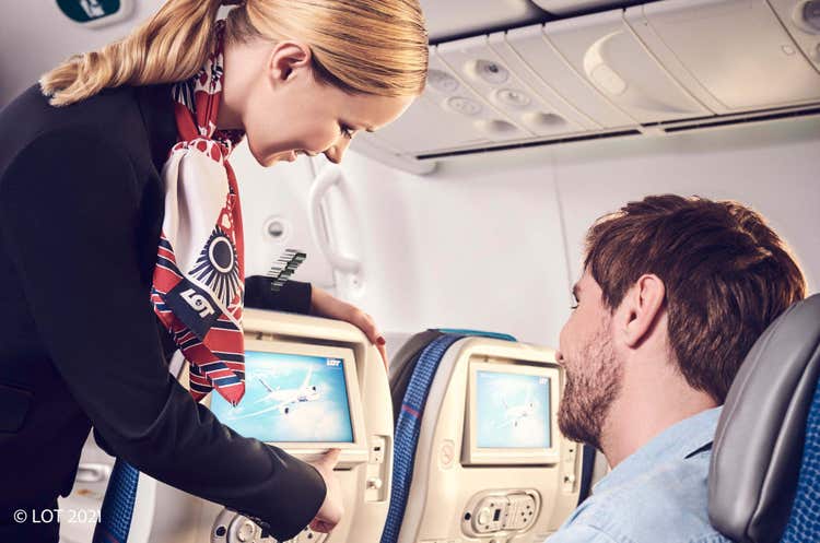 flight attendant helping passenger