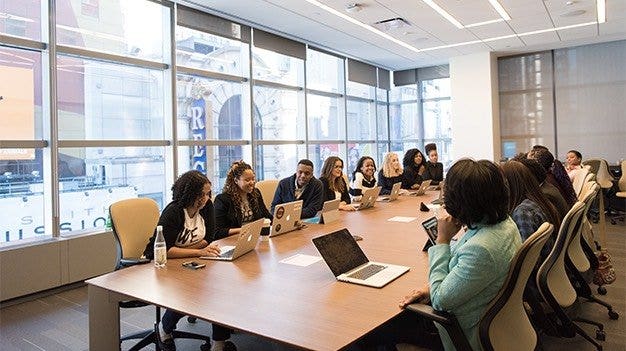 A project management office (PMO) meeting in an office