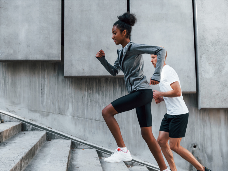 two people running up a staircase