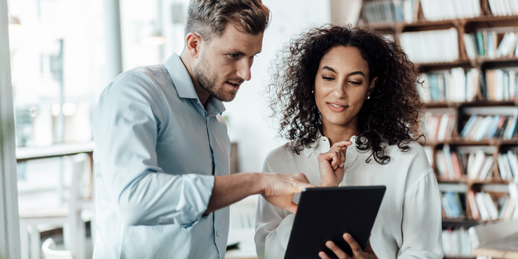 Professionals using project management tools on a tablet