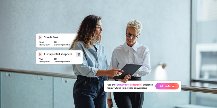 Two women talk while viewing a tablet showing audiences of sports fans and luxury retail shoppers. The app recommends adding the latter to increase conversions.