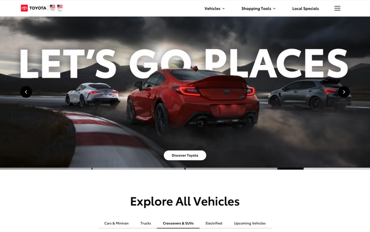 The Toyota website displaying racing cars and the words LET'S GO PLACES is an example of a headless commerce platform.